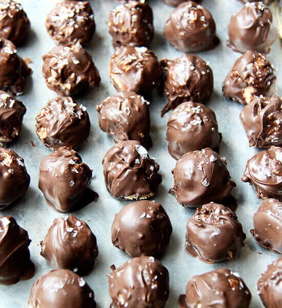 A sheet pan lined with chocolate covered peanut butter balls.