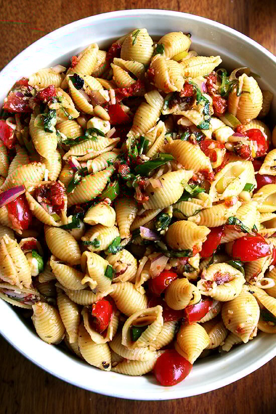 This simple pasta salad is particularly good warm, when the just-boiled shells melt the cheese, just slightly cook the tomatoes and soak up all the flavors of the olive oil and lemon juice. It can also be prepared ahead and served at room temperature โ it tastes better the longer it sits in fact. // alexandracooks.com