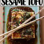 A plate of warm tofu with spicy sesame sauce.