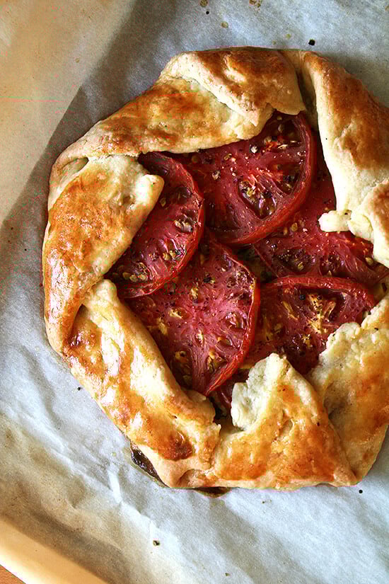 This galette, filled with caramelized onions, fresh corn, basil, Gruyère cheese and heirloom tomatoes, is prefect for the end of summer. Serve it with a simple mixed greens salad or a cucumber-and-feta cheese plate for a light, vegetarian meal. Yum. // alexandracooks.com Freshly baked savory galette with corn, tomatoes, and Gruyère.