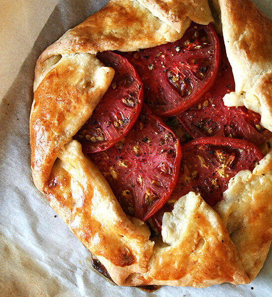 A sheet pan with two freshly baked savory galettes.