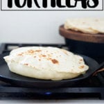 A homemade flour tortilla in a skillet.