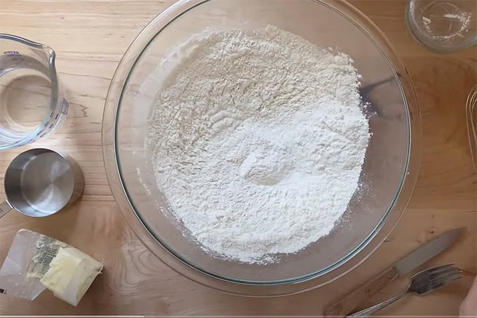 A large bowl of flour, salt and baking powder whisked together.