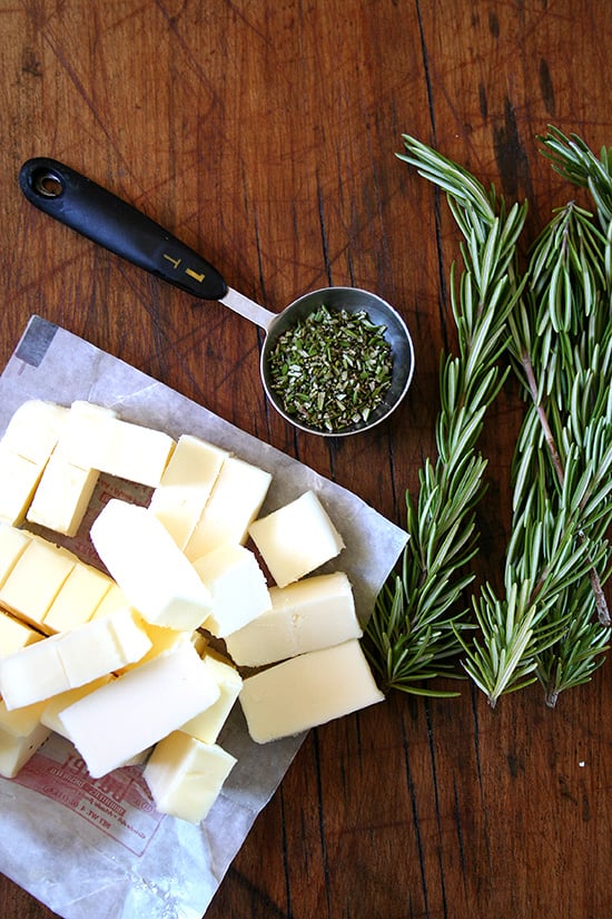 rosemary & butter Ingredients for rosemary shortbread on a board: butter + rosemary.