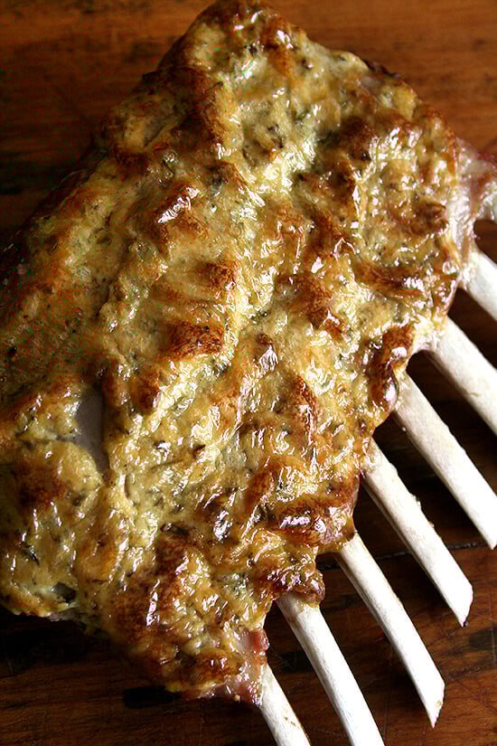 Cooked Rack of Lamb, resting on a board. 