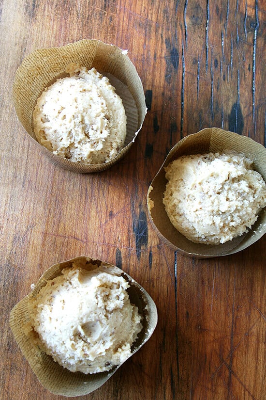batter Decorative muffin liners filled with coffeecake muffin batter.