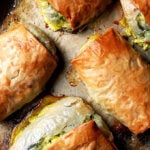 A sheet pan of just-baked spanakopita strudels.