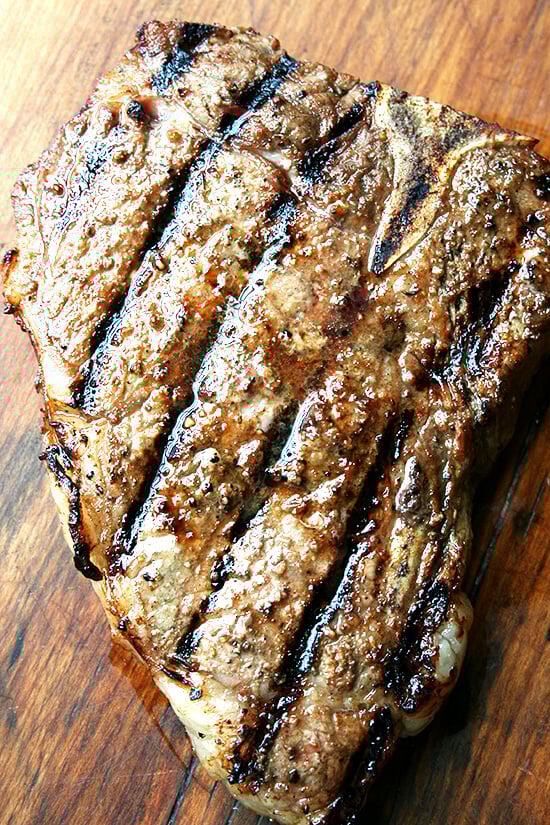 This steak marinade — equal parts Worcestershire sauce and olive oil combined with a healthy sprinkling of lemon pepper — is a good one to have on hand this time of year. What's more, it produces just about the best tasting leftovers, though I can't promise there will be any. // alexandracooks.com A grilled grass-fed t-bone steak, resting on a cutting board.