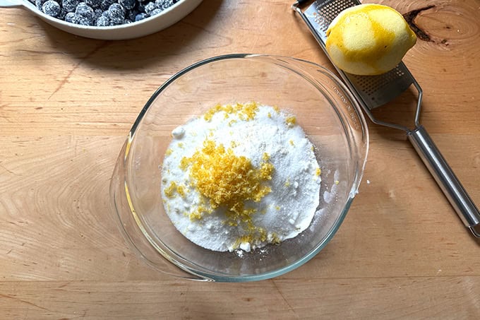 Lemon zest added to the dry ingredients of the topping to make blueberry crisp.