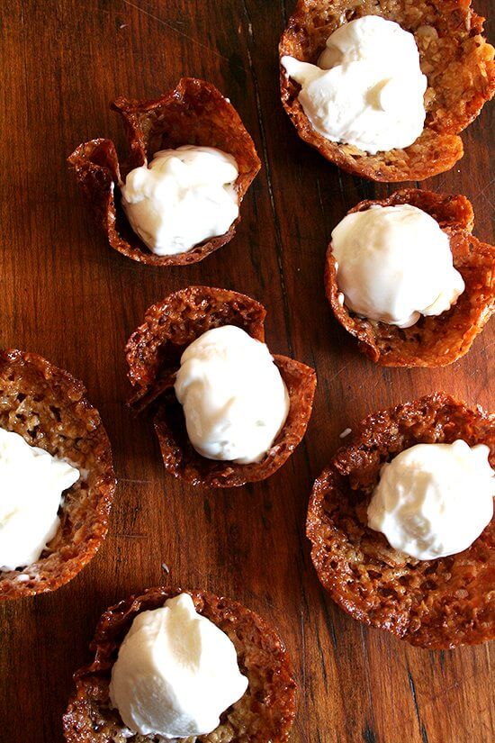 Made with only three ingredients, Greek yogurt, sugar and vanilla, the base for this frozen yogurt comes together in about one minute, and after an hour of chilling, it's ready to be churned — so simple, so delicious. // alexandracooks.com Real frozen yogurt scooped into homemade cookie cups.