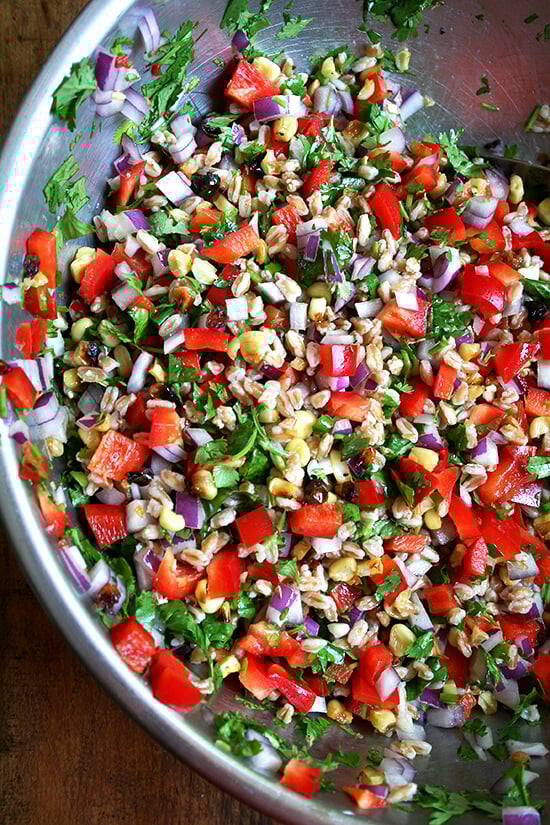 This farro salad, a combination of roasted corn, fresh-squeezed lime juice, cilantro, minced chili peppers and diced peppers and onions, has become a weekly staple. If you strategize by chopping the vegetables and herbs while the corn is roasting and the farro is simmering, this salad can come together in just about 20 minutes. It yields a lot, thanks to all of the add-ins, and tastes better with each passing day. // alexandracooks.com