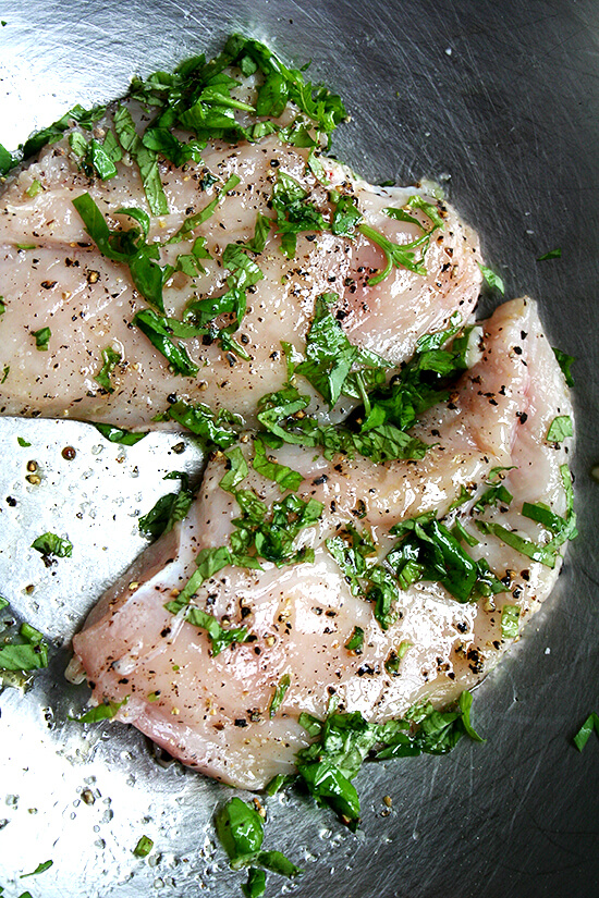 uncooked chicken breasts seasoned with basil, salt and pepper uncooked chicken breasts seasoned with basil, salt and pepper