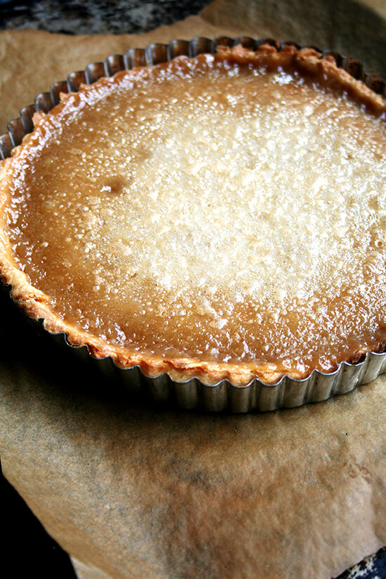 I am in awe of this maple cream tart’s texture. The absence of eggs makes it exceptionally light yet somehow it tastes as smooth and creamy as an untorched crème brûlée. For maple syrup lovers, nothing could be more delicious, and best of all, it’s a cinch to assemble. // alexandracooks.com Just-baked maple cream tart on a sheet pan.