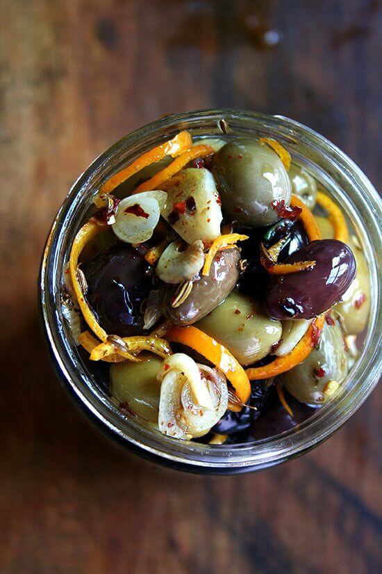 Marinated olives are about as easy as it gets as far as sprucing up the hors d'oeuvres spread goes — a little garlic and orange zest along with a few spices (crushed red pepper flakes and fennel seed) go a long way, and these flavor elements look so pretty in the serving dish as well. // alexandracooks.com Marinated olives are about as easy as it gets as far as sprucing up the hors d'oeuvres spread goes — a little garlic and orange zest along with a few spices (crushed red pepper flakes and fennel seed) go a long way, and these flavor elements look so pretty in the serving dish as well. // alexandracooks.com