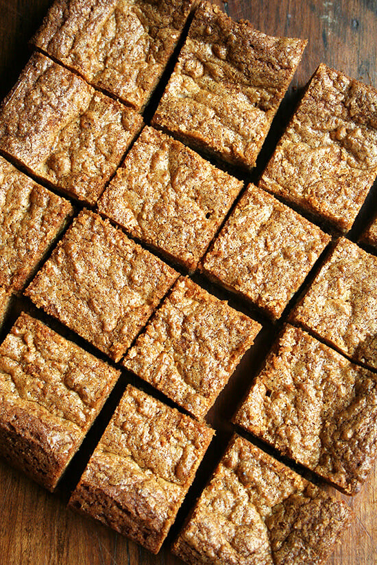 To me, these brown butter blondies are heaven, a perfect balance of sweet and salty, impossible not to nibble on all day long. The brown butter provides all of the nuttiness and deliciousness promised by its many fans. These are particularly good with a glass of milk, but I can't pretend I haven't enjoyed them aside morning coffee and afternoon tea as well. // alexandracooks.com Cut brown butter blondies on a board.