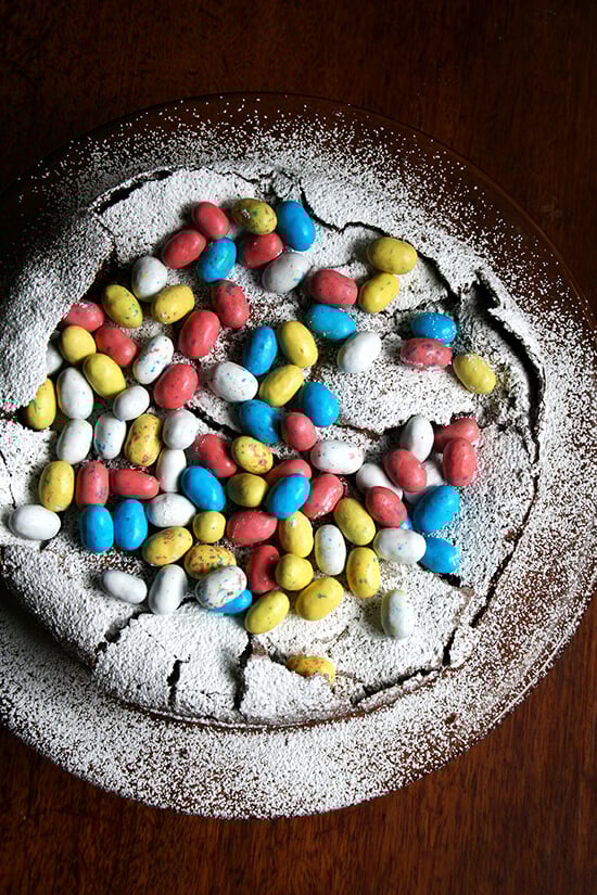 This rich chocolate Easter egg nest cake is festive and fun, puffing way up when it bakes and sinking when it cools, a crackly meringue-like layer forming a perfect base to house dozens of colorful candy eggs. // alexandracooks.com This rich chocolate Easter egg nest cake is festive and fun, puffing way up when it bakes and sinking when it cools, a crackly meringue-like layer forming a perfect base to house dozens of colorful candy eggs. // alexandracooks.com