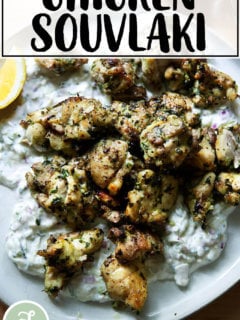 Chicken souvlaki on a plate with tzatziki.