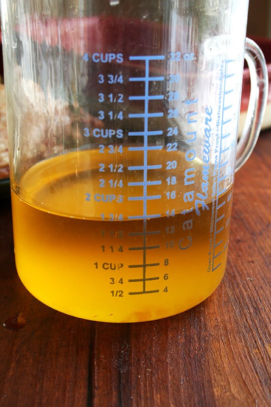 A liquid measure filled with rendered duck fat and butter.