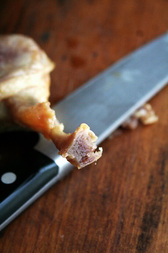 The tip of the duck leg confit bone cut off.