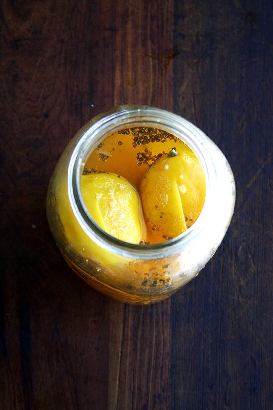 An overhead shot of preserved lemons à la bon appetit in a jar. 