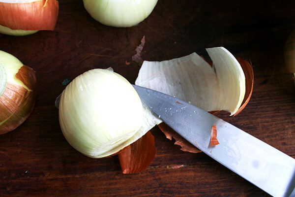 A peeled onion on a board.