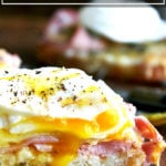 Croque madame — croque monsieur topped with a poached egg — on a cutting board.