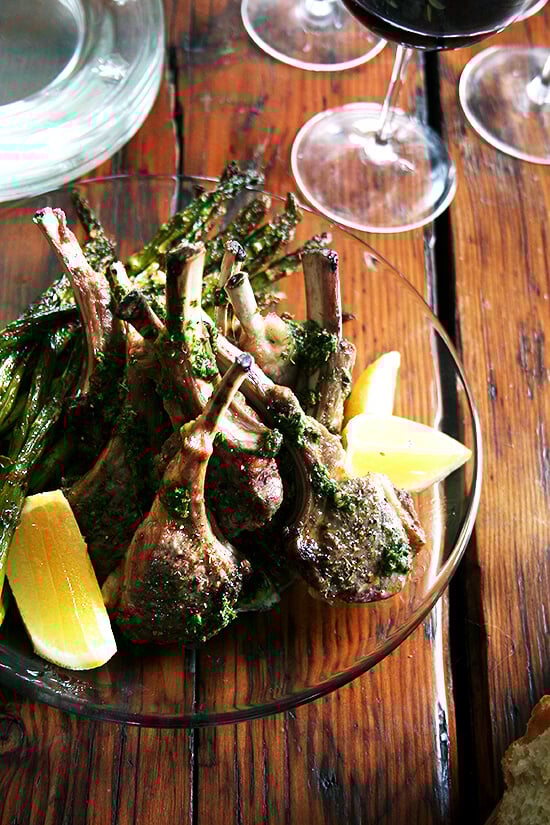 Bright green and fresh, these broiled lamb chops with mint sauce bear no resemblance to mint jelly and taste more like a salsa verde or a nut- and cheese-free pesto. It complements the lamb so well, but it's the kind of sauce you'll end up drizzling all over your plate, dragging your spears of roasted asparagus through, and mopping up with your bread throughout your meal. // alexandracooks.com A platter of broiled lamb chops drizzled with mint sauce.