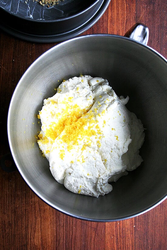 Lemon zest & ricotta in the bowl of a stand mixer.