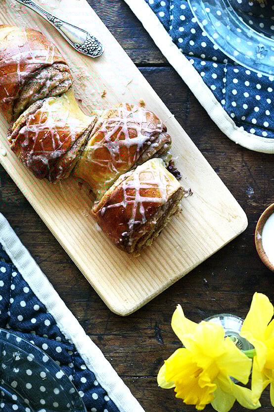 This is my favorite cinnamon pull-apart bread. The loaf stretches from corner to corner of the sheetpan and oozes with cinnamon and sugar upon baking. You'll tuck in immediately, pulling at the nearest coil, spreading cream cheese icing over each bite, eating and talking and sipping coffee until not a crumb remains. // alexandracooks.com Cinnamon pull-apart bread on a board.