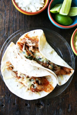 A plate of 2 chicken tinga tacos.