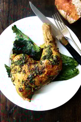 A plate of crispy roast chicken with herb sauce.