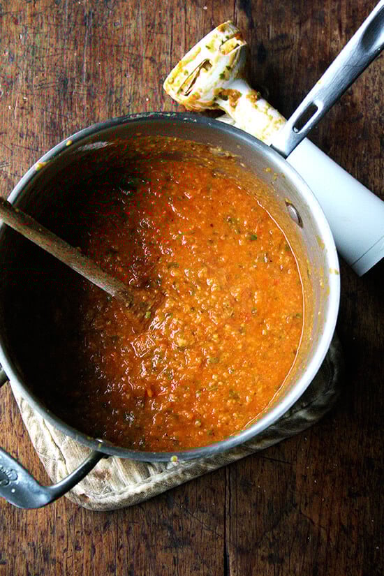 In this roasted tomato and bread soup, slow-roasting the tomatoes, onions, carrots and garlic concentrates all of the flavors, making any liquid but water unnecessary. I have no doubt this soup will make an impression in your heart and mind. // alexandracooks.com A pot of puréed roasted tomato and bread soup.