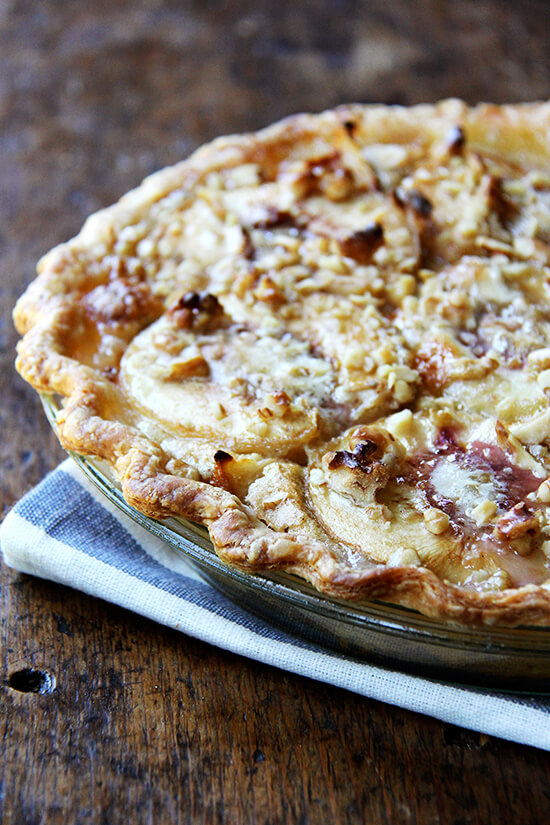 German peach pie, which may or may not be German at all, is like an open-faced pie made with four halved, peeled peaches topped with a butter-sugar-egg mixture and a small sprinkling of nuts. When it bakes, this vanilla custard bubbles around the peach halves, which, after the hour in the oven, become spoon tender and are utterly delicious. Vanilla ice cream is a must as is a crew to help polish off the spoils, though pie for breakfast isn't the worst thought either. // alexandracooks.com German peach pie, which may or may not be German at all, is like an open-faced pie made with four halved, peeled peaches topped with a butter-sugar-egg mixture and a small sprinkling of nuts. When it bakes, this vanilla custard bubbles around the peach halves, which, after the hour in the oven, become spoon tender and are utterly delicious. Vanilla ice cream is a must as is a crew to help polish off the spoils, though pie for breakfast isn't the worst thought either. // alexandracooks.com