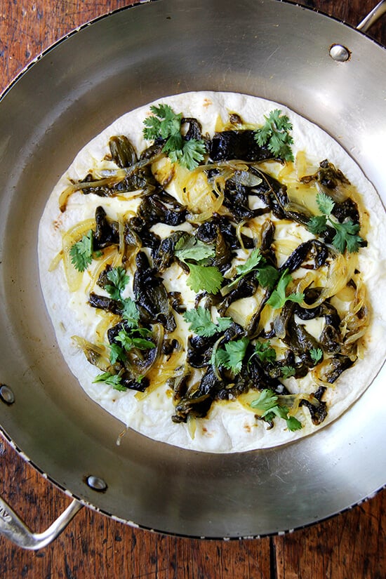 There is something so good about this simple quesadilla, about tasting each element — the smoky peppers and sweet onions, the bright cilantro, the creamy, melty Jack. As with pizza, less is more with quesadillas — a thin layer of ingredients is best. Before serving, I love stretching open the cheese-locked layers and dropping in spoonfuls of sour cream. // alexandracooks.com There is something so good about this simple quesadilla, about tasting each element — the smoky peppers and sweet onions, the bright cilantro, the creamy, melty Jack. As with pizza, less is more with quesadillas — a thin layer of ingredients is best. Before serving, I love stretching open the cheese-locked layers and dropping in spoonfuls of sour cream. // alexandracooks.com