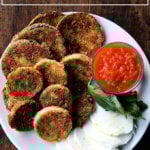 a plate of crispy eggplant rounds, mozzarella, basil, tomato sauce