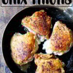 A skillet of chicken thighs with preserved lemon.