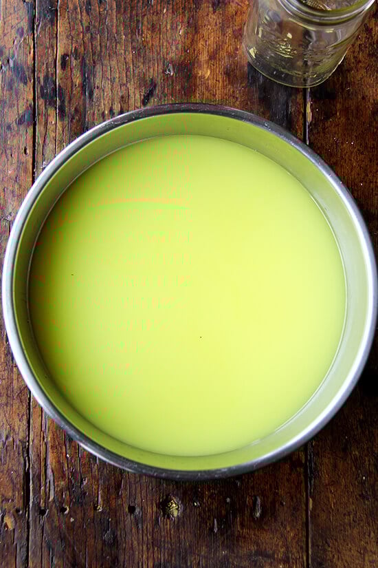 A large bowl filled with simple syrup and lemon-infused grain alcohol.