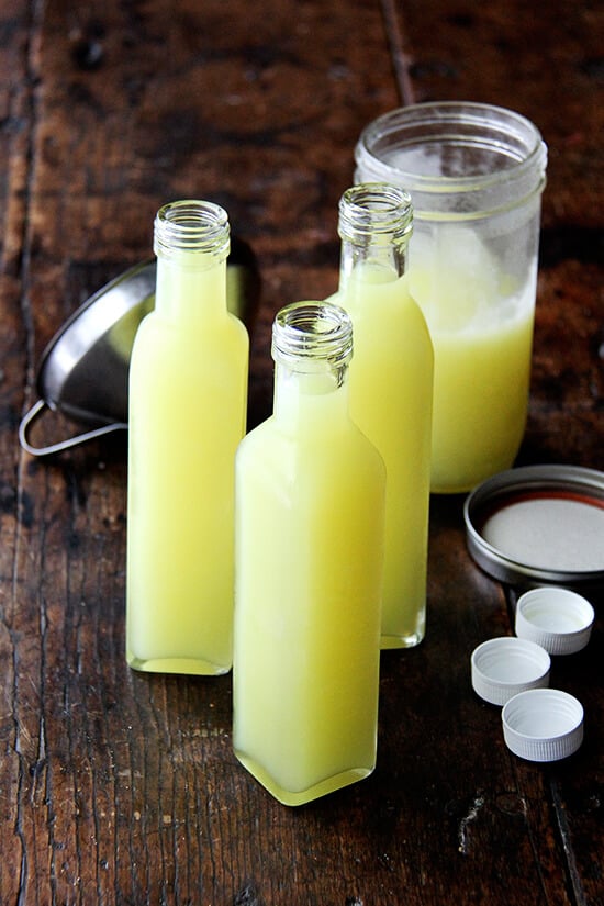 This recipe for limoncello is a two-phase process, but is very simple. It makes a great gift and thus far has been very well received. I like to drink it topped with heavy cream. Yum. // alexandracooks.com Tall, narrow glass bottles filled with homemade limoncello.