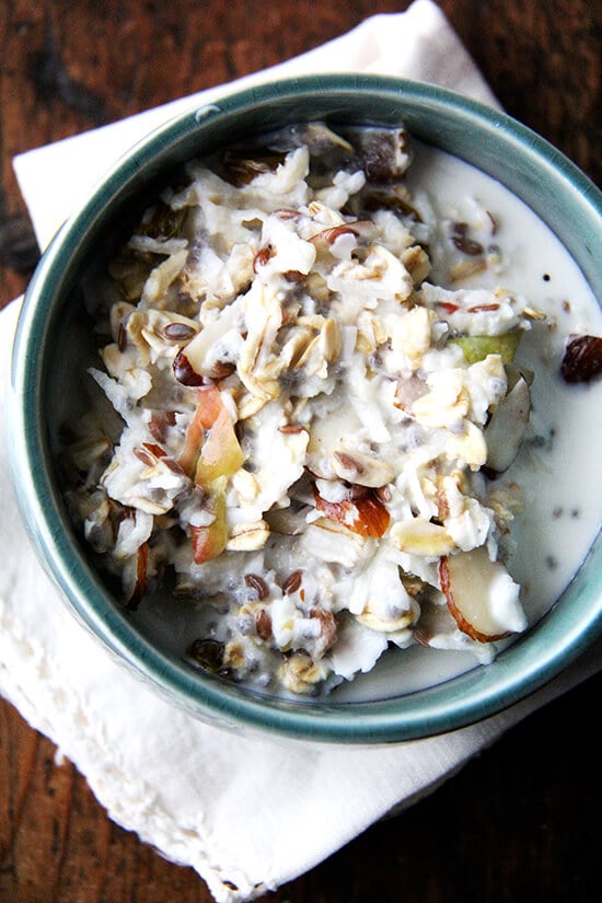 There are countless ways to make Bircher muesli, but the basic idea is that you throw raw oats, nuts, and dried fruit into a bowl and soak them in milk. It's so nice having an enormous vat, hideous storage container and all, of muesli sitting on my counter — truly, I feel lost in the morning when we are out. // alexandracooks.com A bowl of Bircher muesli.