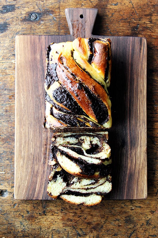 I love this babka hybrid — can't stop eating it! — and as soon as I finish off the remaining loaf on my counter, I am locking up all of my flours and leavening agents and chocolate, and I am putting an end to this baking spree once and for all! // alexandracooks.com A board with orange-chocolate babka, sliced