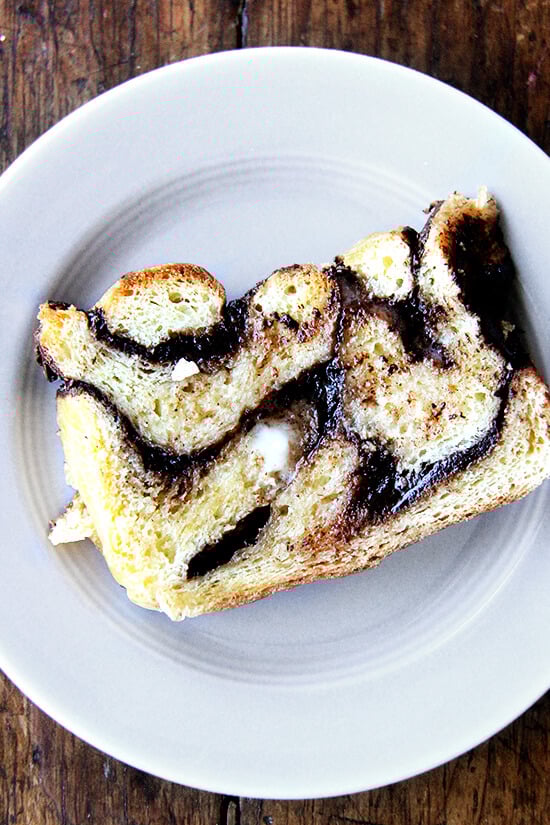 day old babka, toasted, spread with butter on a plate