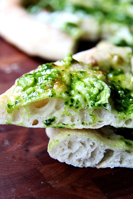 In this pesto pizza, while the pizza isn't baked completely naked, the process is similar: scatter cheese lightly across dough, drizzle it with olive oil and bake it until bubbling. Immediately upon pulling it from the oven, brush it with a thinned-out ramp pesto and a sprinkling of sea salt. Withholding the pesto from the pizza until it's out of the oven preserves not only its sharp, punchy flavor but also its vibrant green color. // alexandracooks.com In this pesto pizza, while the pizza isn't baked completely naked, the process is similar: scatter cheese lightly across dough, drizzle it with olive oil and bake it until bubbling. Immediately upon pulling it from the oven, brush it with a thinned-out ramp pesto and a sprinkling of sea salt. Withholding the pesto from the pizza until it's out of the oven preserves not only its sharp, punchy flavor but also its vibrant green color. // alexandracooks.com