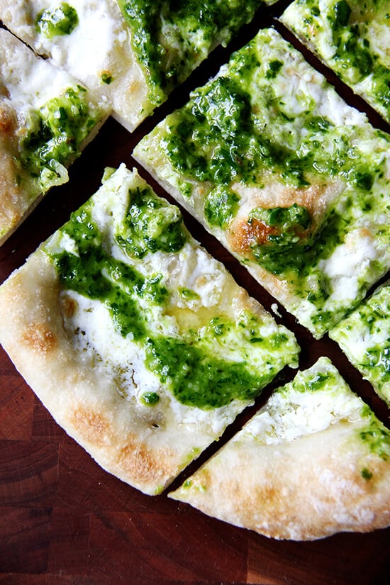 In this pesto pizza, while the pizza isn't baked completely naked, the process is similar: scatter cheese lightly across dough, drizzle it with olive oil and bake it until bubbling. Immediately upon pulling it from the oven, brush it with a thinned-out ramp pesto and a sprinkling of sea salt. Withholding the pesto from the pizza until it's out of the oven preserves not only its sharp, punchy flavor but also its vibrant green color. // alexandracooks.com In this pesto pizza, while the pizza isn't baked completely naked, the process is similar: scatter cheese lightly across dough, drizzle it with olive oil and bake it until bubbling. Immediately upon pulling it from the oven, brush it with a thinned-out ramp pesto and a sprinkling of sea salt. Withholding the pesto from the pizza until it's out of the oven preserves not only its sharp, punchy flavor but also its vibrant green color. // alexandracooks.com
