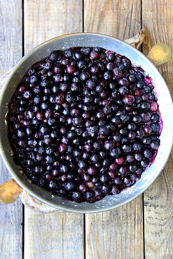 A pie plate with baked blueberries —step 3 of blueberry cobbler recipe.