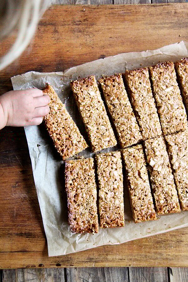 In these granola bars, I use oats, coconut, almonds and millet for the dry ingredients, the same makeup as the granola. For the glue, I use coconut oil or butter, maple syrup, brown rice syrup and almond butter. They hold their shape at room temperature and have thus become a lunch box staple. // alexandracooks.com In these granola bars, I use oats, coconut, almonds and millet for the dry ingredients, the same makeup as the granola. For the glue, I use coconut oil or butter, maple syrup, brown rice syrup and almond butter. They hold their shape at room temperature and have thus become a lunch box staple. // alexandracooks.com