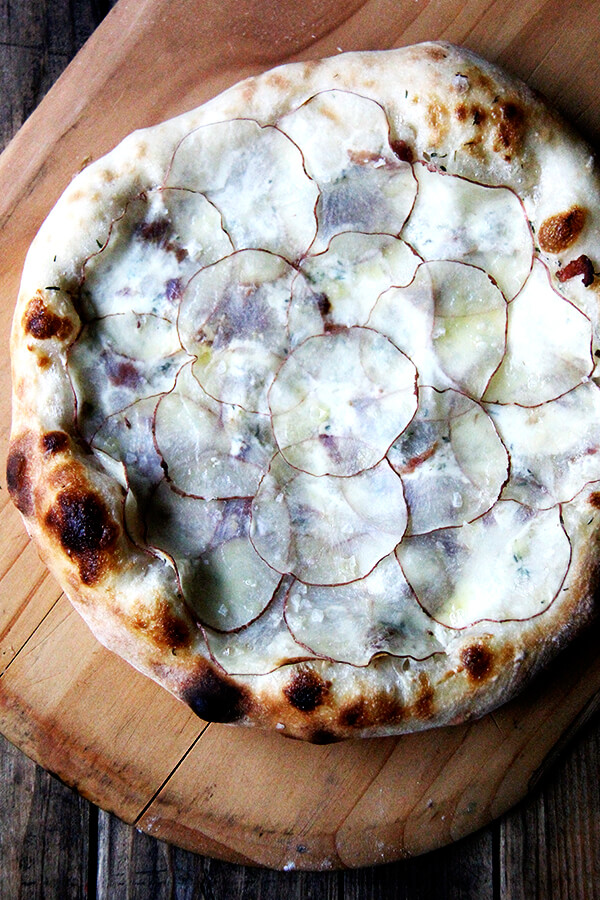 The paper-thin potatoes on this potato pizza require no pre-cooking, and a drizzle of olive oil and sea salt overtop renders additional cheese unnecessary. This has to be one of my all-time favorite pizzas (feeling bold!) though I have no doubt the fresh potatoes play a role here. Also bacon. And crème fraîche. // alexandracooks.com The paper-thin potatoes on this potato pizza require no pre-cooking, and a drizzle of olive oil and sea salt overtop renders additional cheese unnecessary. This has to be one of my all-time favorite pizzas (feeling bold!) though I have no doubt the fresh potatoes play a role here. Also bacon. And crème fraîche. // alexandracooks.com