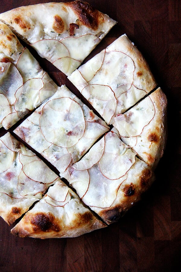 The paper-thin potatoes on this potato pizza require no pre-cooking, and a drizzle of olive oil and sea salt overtop renders additional cheese unnecessary. This has to be one of my all-time favorite pizzas (feeling bold!) though I have no doubt the fresh potatoes play a role here. Also bacon. And crème fraîche. // alexandracooks.com The paper-thin potatoes on this potato pizza require no pre-cooking, and a drizzle of olive oil and sea salt overtop renders additional cheese unnecessary. This has to be one of my all-time favorite pizzas (feeling bold!) though I have no doubt the fresh potatoes play a role here. Also bacon. And crème fraîche. // alexandracooks.com