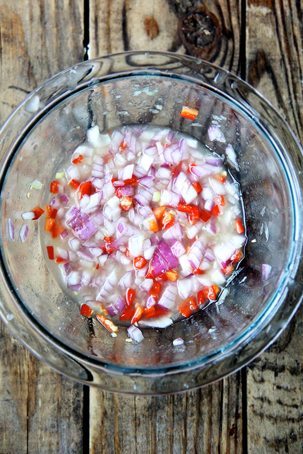 macerated shallots and chilies in a bowl.