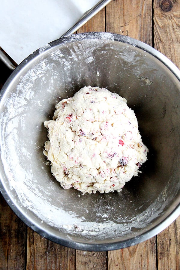 A large bowl filled with cranberry scone dough all mixed up.