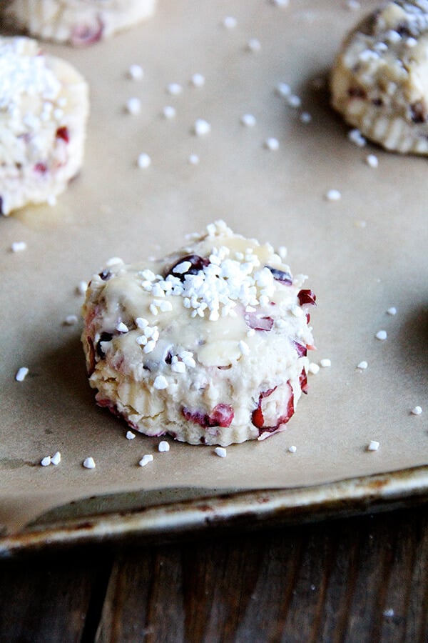 These cranberry scones are a delightful Christmas treat that are satisfying, beautiful, and so easy to whip together! // alexandracooks.com A tray of unbaked pearl sugar-topped cranberry scones.